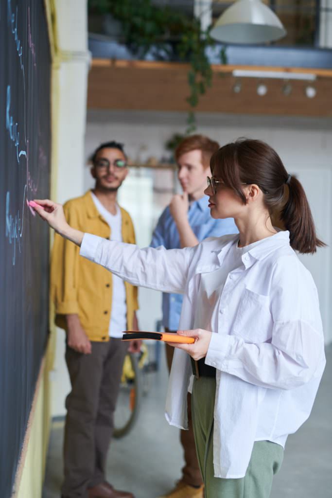An awesome stock photograph by Fauxels of a woman teaching.
